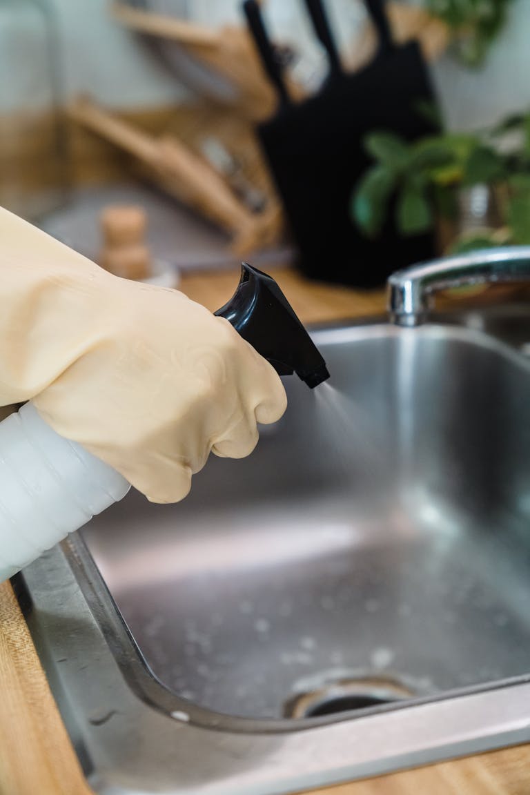 A Person Cleaning the Kitchen Sink